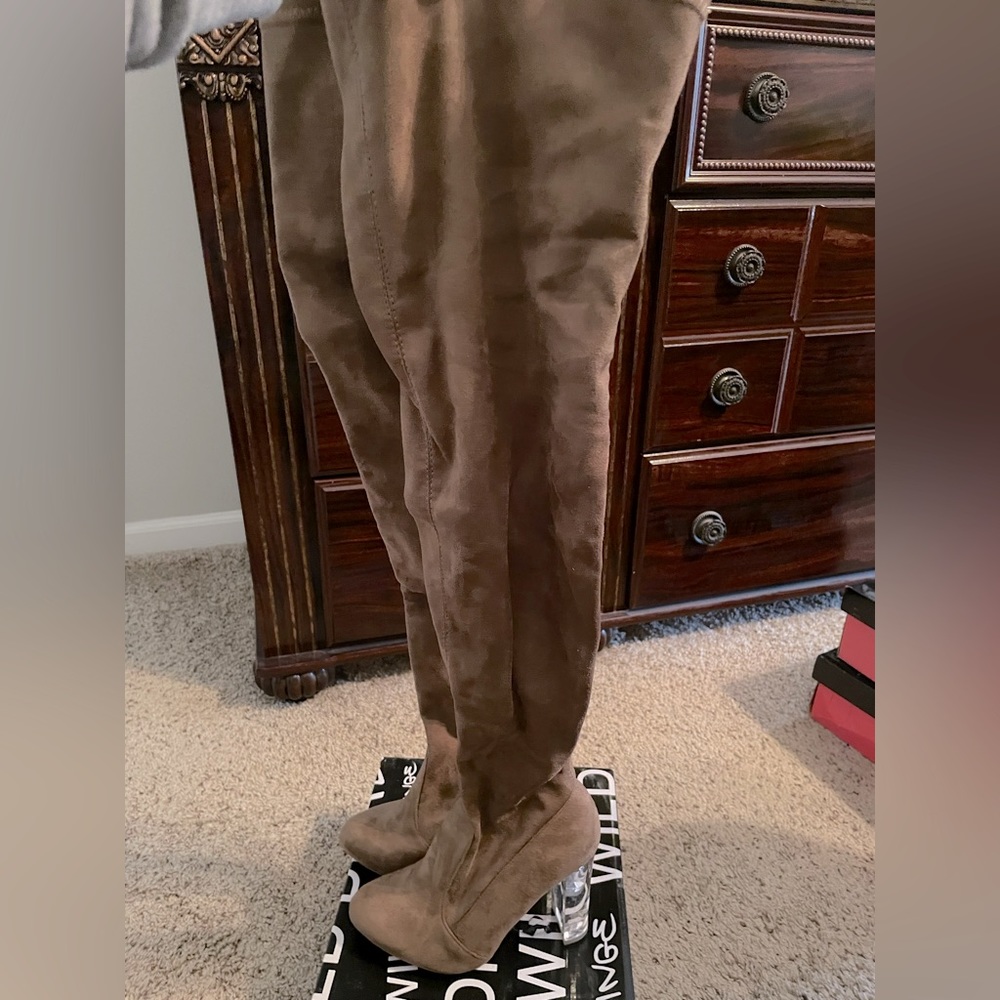 Over the knee suede boots with clear heel.
